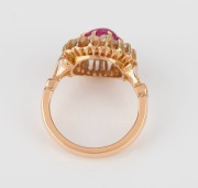 An 18ct yellow gold ring, set with a cabochon ruby surrounded by white diamonds, stamped "750", ​​​​​​​6.5 grams - 4