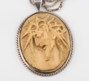 A vintage carved ivory pendant depicting Christ with crown of thorns, mounted in a sterling silver frame, suspended on a silver box-link chain, 20th century, ​​​​​​​the pendant 5.5cm high - 2