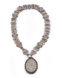 An antique sterling silver photo locket with engraved decoration, suspended on original chain, circa 1875, the locket 5.5cm high including loop