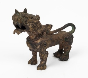 An antique Chinese bronze lion statue with remains of gilded finish, unknown age, 8.5cm high, 11cm long