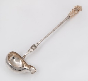 An antique silver ladle with shell decoration and carved mother of pearl handle, 19th century, marks rubbed but possibly a Moscow Russian silver assay mark, 43cm long