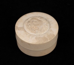 An antique Japanese circular trinket box, carved ivory with lion decoration, Meiji period, 19th century, ​​​​​​​4cm high, 6.5cm diameter
