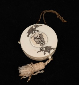 An antique Japanese circular compact, carved ivory with elephant and lion decoration, Meiji period, 20th century, 6.5cm diameter