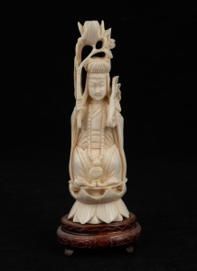A Chinese carved ivory statue of a seated figure with lotus flower, on carved and inlaid timber stand, mid 20th century, ​​​​​​​18cm high overall