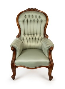 An antique Australian carved cedar armchair with green diamond button back upholstery, 19th century, 106cm high, 67cm across the arms