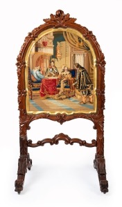 An antique English carved rosewood fire screen with arched top and tapestry court scene, circa 1850, 122cm high, 62cm wide, 52cm deep
