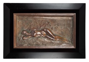 An antique bronze wall plaque of a reclining nude housed in ebonized frame, 19th/20th century, signed lower left (illegible), plaque 37 x 64cm, 59 x 86cm overall
