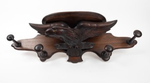 An antique wall mounted oak coat rack with carved spread-eagle decoration, 19th century, 78cm wide