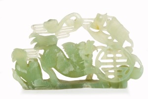 A Chinese carved jade foo dog ornament, 20th century, 19cm high, 33cm wide