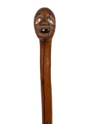 An antique rootstock walking stick,&nbsp;unusual carved head handle with bone inlaid eyes and silver tooth, 19th century, 90cm high