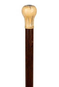 An antique walking stick with whale tooth handle and timber shaft, (missing ferrule), 19th century, 89cm high