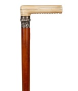 An antique walking stick with carved ivory handle, embossed silver collar, Malacca cane shaft and brass ferrule, ​​​​​​​85cm high