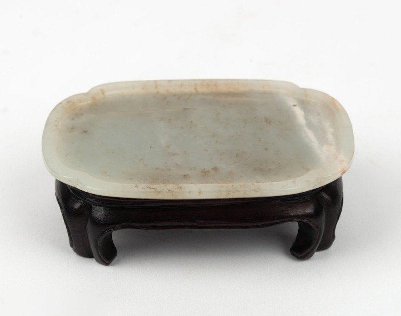 An antique Chinese white jade dish on later carved wooden stand, Chien Lung period, 18th century. Accompanied by a letter dated 29th, January, 1966 from DUNT KING (Hong Kong). 8.2cm wide