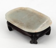 An antique Chinese white jade dish on later carved wooden stand, Chien Lung period, 18th century. Accompanied by a letter dated 29th, January, 1966 from DUNT KING (Hong Kong). 8.2cm wide - 2