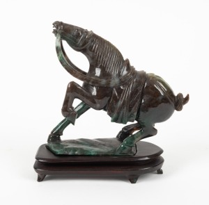 A vintage Chinese carved jade horse statue on wooden base, 20th century, 17cm high overall