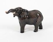 BESWICK English porcelain elephant statue with raised trunk, 20th century, black factory mark to base, 12cm high, 18cm long