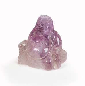 A Chinese carved amethyst rock crystal seated Buddha statue, 19th/20th century, ​​​​​​​5.5cm high