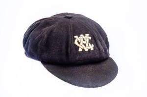 KEN MEULEMAN'S VICTORIA CRICKET CAP, deep navy blue (almost black), with embroidered "VCA" monogram on front, signed inside by Ken Meuleman. Fair/Good match-worn condition (some soiling). [Ken Meuleman played 1 Test 1945-46, and played for Victoria 1945-5