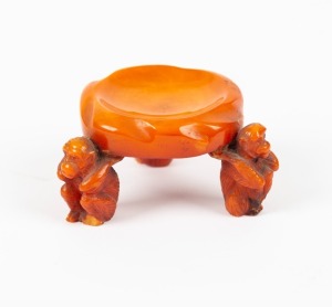 An antique Chinese carved amber brush washer with monkey legs, Qing Dynasty, 18th/19th century, ​​​​​​​4cm high, 7cm wide