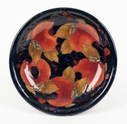 MOORCROFT "Pomegranate" English pottery plate on dark&nbsp;blue ground, impressed "Moorcroft, Made in England", 18.5cm diameter