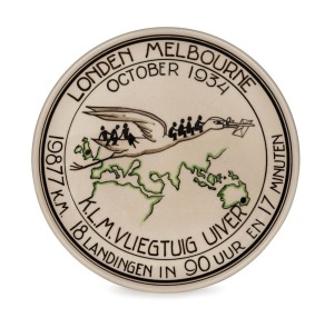 THE LONDON to MELBOURNE, MacROBERTSON CENTENARY AIR RACE 1934: Porcelain hanging plaque by Koninklyk Goedewaagen Gouda (and numbered "143" on reverse), 18.5cm diameter; depicting a stork (Uiver in Dutch) carrying passengers and mail over the route from London to Melbourne; created to celebrate the success of the KLM aeroplane in this important air race.