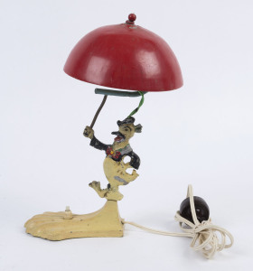 DONALD DUCK: Art Deco&nbsp;painted metal lamp featuring Donald holding a large red umbrella forming the shade; some paint loss, c.1930s, ​​​​​​​35cm high
