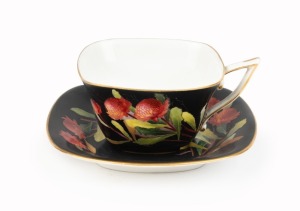 ROYAL WORCESTER "Waratah" antique English porcelain cup and saucer on rare black ground, signed "E. PHILLIPS", puce factory mark to base "Royal Worcester, Waratah, Flavelle Brothers Ltd.", the saucer 12cm wide