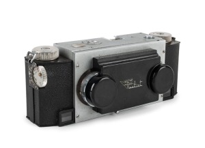 WHITE: Stereo Realist Model 1041 stereo camera [#003951], c. 1947, with dual f3.5 lenses. Unusual design with viewfinder at bottom of camera and integrated flip-up lens cap.