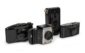 VARIOUS MANUFACTURERS: Four black-Bakelite cameras - one c. 1929 APM Rajar No. 6 with leather case, one c. 1937 Hunter Purma Special with lens cap, one c. 1938 MIOM Photax Blinde with lens cap, and one c. 1970 Foto-Flex. (4 cameras)