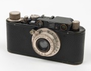LEITZ: Black-body/chrome-fittings Leica II Model D rangefinder camera [#86985], c. 1932, with Elmar 50mm f3.5 lens, front lens cap, and leather case. - 2