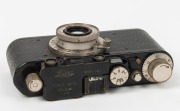 LEITZ: Black-body/chrome-fittings Leica II Model D rangefinder camera [#86985], c. 1932, with Elmar 50mm f3.5 lens, front lens cap, and leather case. - 3