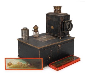 ERNST PLANK: Children's magic lantern, height 24.5cm, in maker's wooden box with eleven glass slides, c. 1890s.