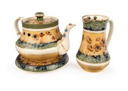 MACINTYRE antique English poppy patterned pottery teapot, trivet and milk jug designed by WILLIAM MOORCROFT,&nbsp;19th/20th&nbsp;century, (3 items), brown factory mark to bases, the jug 15cm high