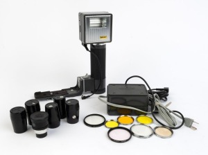 NIPPON KOGAKU: Fourteen accessories - one Nikon SB-1 flash together with sync cable/SK-2 bracket/SA-1 AC Unit & Charger, seven lens filters, one Nikkorex-8 Tele 2x lens converter with front and rear caps, and five film cartridges each in film canister. (1