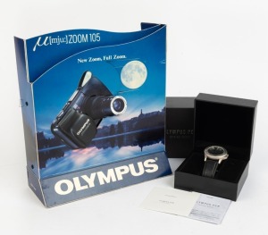 OLYMPUS: 25.5cm tall battery-powered Mju: Zoom 105 point-of-sale display, together with one Olympus Pen wristwatch with Pen-F logo on face in box with instruction booklet. (2 items)