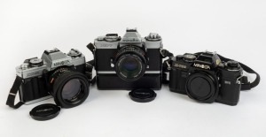 MINOLTA: Three c. 1980 SLR cameras - one XG-M with MD Rokkor 50mm f1.7 lens, lens hood, and front lens cap, one XD-7 with MD Rokkor 50mm f1.7 lens and front lens cap, and one black X-700 camera body with body cap. (3 cameras)