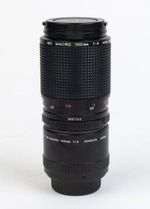 MINOLTA: MD Macro 100mm f4 lens [#8007346], with 1:2-1:1 macro tube adapter ring and front and rear lens caps.