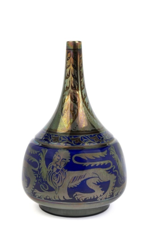 PILKINGTON ROYAL LANCASTRIAN bottle shape rich ruby & blue lustre glazed vase adorned with lions and trailing foliate motif, signed "W. S. Mycock, 1923", 23cm high