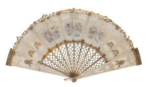 A stunning antique carved mother of pearl fan, sumptuously hand-painted and crafted in three coloured 18ct gold and mounded with diamonds, rubies and emerald. Most likely French, and made as a special commission probably for a member of the Russian aristocracy, 18th/19th century. By far the finest example ever seen in our rooms. 23cm high, 40cm wide