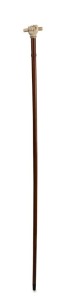 An antique walking stick with carved ivory fist handle, stained timber shaft and horn ferrule, 19th century, 87cm high