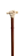 An antique walking stick with carved ivory fist handle, stained timber shaft and horn ferrule, 19th century, ​​​​​​​87cm high - 2