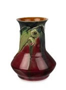 REMUED pottery vase with applied gumnuts and leaf, glazed in pink, green and blue with brown interior, incised "Remued", 14.5cm high