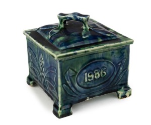 E. J. KELLY (HARVEY SCHOOL) pottery lidded butter dish with mottled green and blue glaze, emblazoned in cartouche "E. K. J.", incised "E. J. Kelly, 1936", 15cm high, 15cm wide, 14cm deep