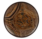 CARL COOPER pottery plate with Aboriginal designs, incised "Carl Cooper, Australia, 1950", ​​​​​​​21.5cm diameter