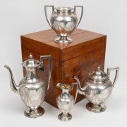 An antique English four piece sterling silver tea service with engraved decoration, housed in original fitted oak case, manufactured by Thomas Shepherd of London, circa 1877, the largest 30cm high, 2388 grams total