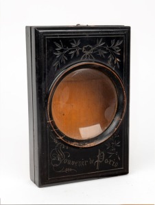 21 x 14 x 4cm folding graphoscope with magnifier lens, photograph holder, and carved floral decorative pattern that reads 'Souvenir de Paris'.