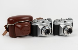 NEDINSCO: Two c. 1958 Primo viewfinder cameras with differing engraving details, one of which in leather case. (2 cameras)