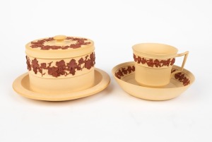 WEDGWOOD unglazed "Caneware" antique English pottery lidded pot with teacup and saucer, decorated in terracotta trailing grape motif, circa 1840, (3 items), impressed "WEDGWOOD", the saucer 14cm diameter