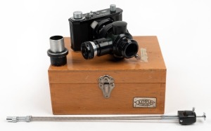 OLYMPUS: Black-body PM-6 microscope camera [#202052], c. 1954, with shutter release cable, barrel adapter element, and maker's wooden box bearing 'Olympus Tokyo' plate.