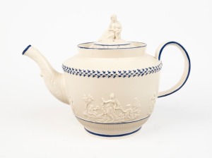 An antique English sprigged pottery teapot with figural finial and blue trim, circa 1790, 17.5cm high, 26.5cm wide
